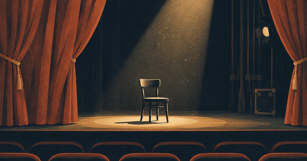 A theatre stage with a half-open curtain and a spotlight on an empty chair